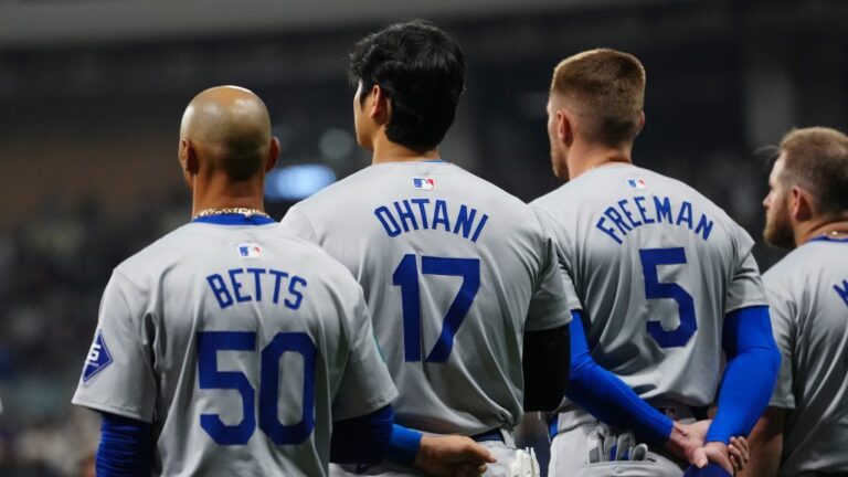 Mookie Betts #50, Shohei Ohtani #17 and Freddie Freeman #5 of the Los Angeles Dodgers look on during the national anthem prior to the 2024 Seoul Series game between the Los Angeles Dodgers and the San Diego Padres at Gocheok Sky Dome.