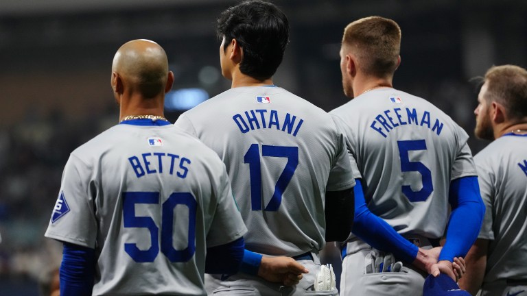 Mookie Betts #50, Shohei Ohtani #17 and Freddie Freeman #5 of the Los Angeles Dodgers look on during the national anthem prior to the 2024 Seoul Series game between the Los Angeles Dodgers and the San Diego Padres at Gocheok Sky Dome.