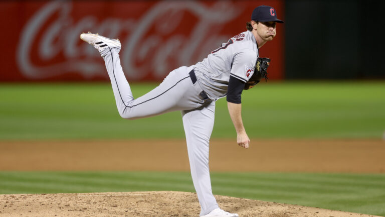 Shane Bieber #57 of the Cleveland Guardians pitches against the Oakland Athletics at Oakland Coliseum.