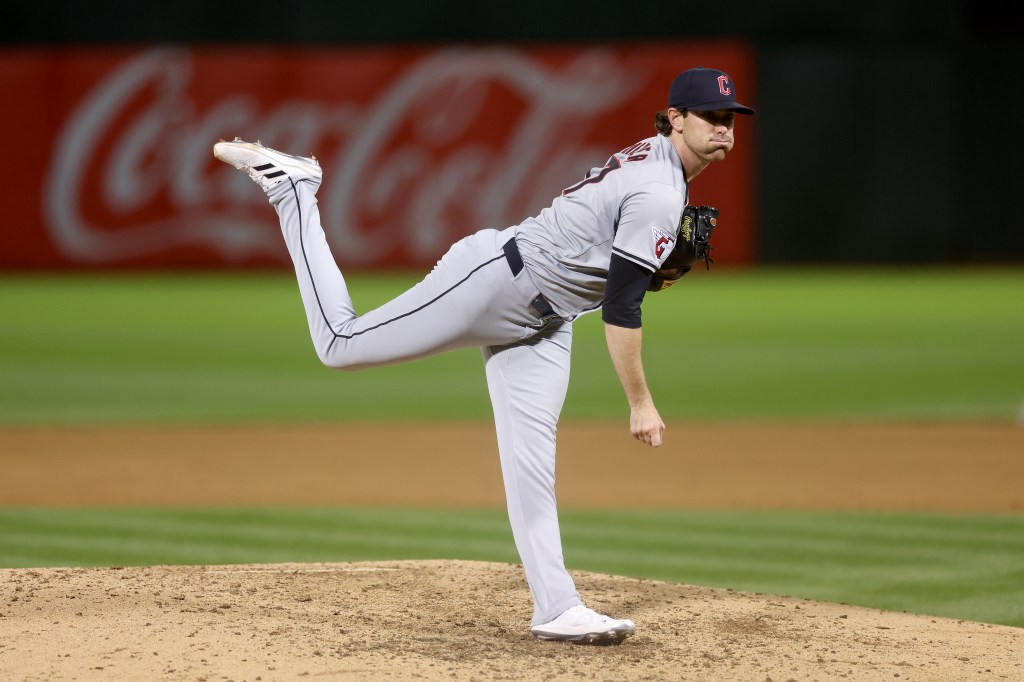 Shane Bieber #57 of the Cleveland Guardians pitches against the Oakland Athletics at Oakland Coliseum.