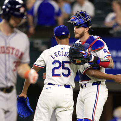 José Leclerc and teammate Jonah Heim of the Texas Rangers celebrate the team's win over the Houston Astros following the game at Globe Life Field.