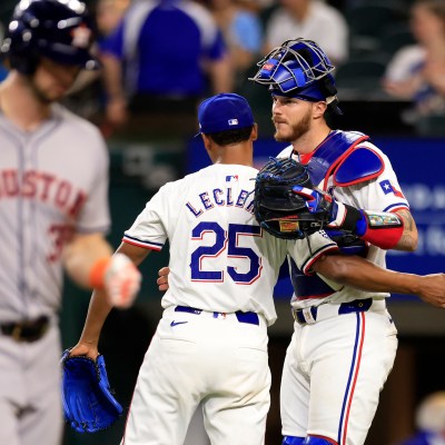 José Leclerc and teammate Jonah Heim of the Texas Rangers celebrate the team's win over the Houston Astros following the game at Globe Life Field.
