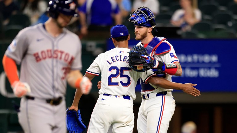 José Leclerc and teammate Jonah Heim of the Texas Rangers celebrate the team's win over the Houston Astros following the game at Globe Life Field.