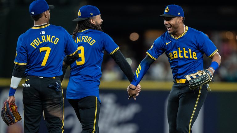 Jorge Polanco #7, J.P. Crawford #3 and Julio Rodriguez #44 of the Seattle Mariners celebrate after a game against the Chicago Cubs at T-Mobile Park.