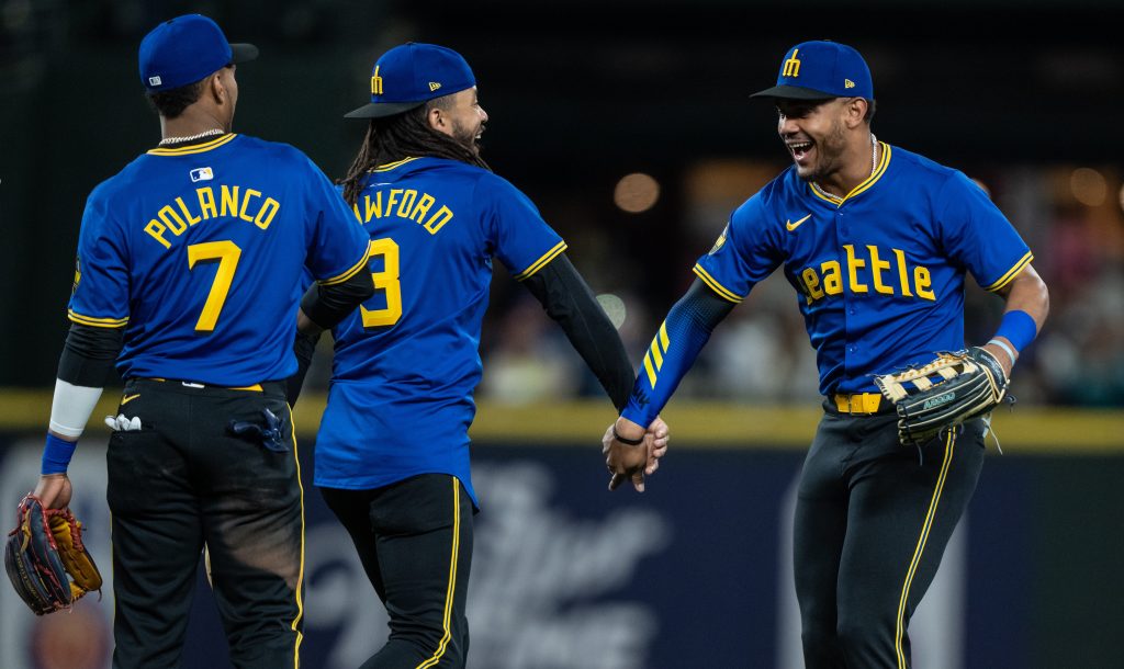 Jorge Polanco #7, J.P. Crawford #3 and Julio Rodriguez #44 of the Seattle Mariners celebrate after a game against the Chicago Cubs at T-Mobile Park.