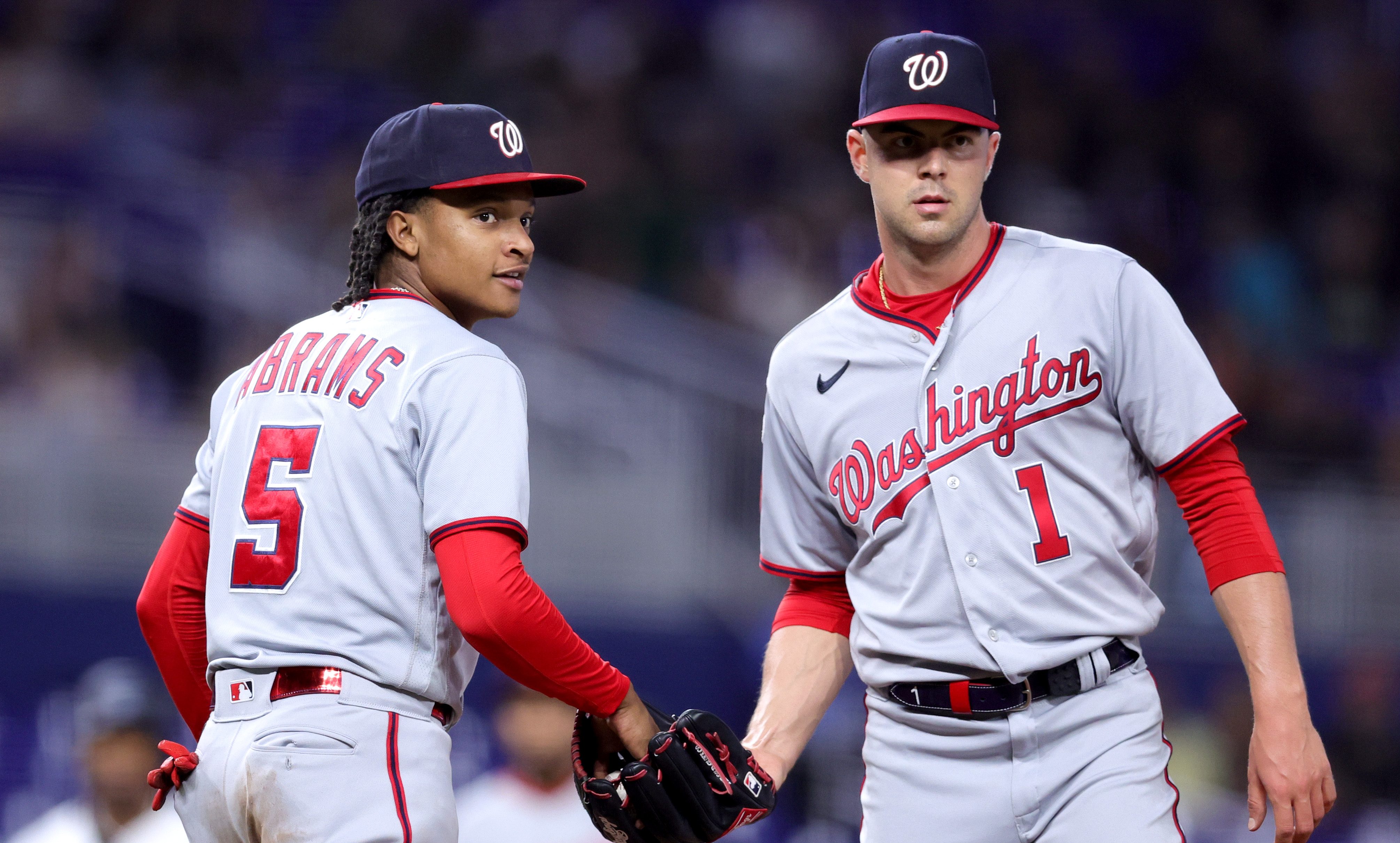 CJ Abrams #5 and MacKenzie Gore #1 of the Washington Nationals look on against the Miami Marlins during the fourth inning at loanDepot Park.
