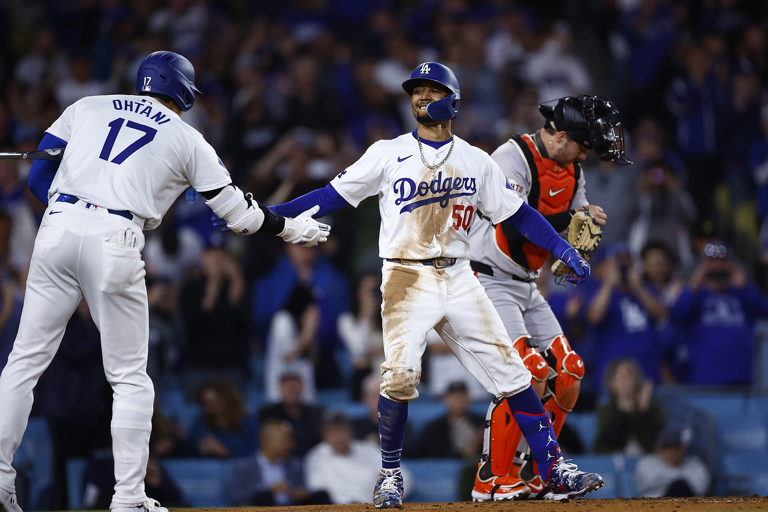 Mookie Betts of the Los Angeles Dodgers celebrates a home run with Shohei Ohtani against the San Francisco Giants.