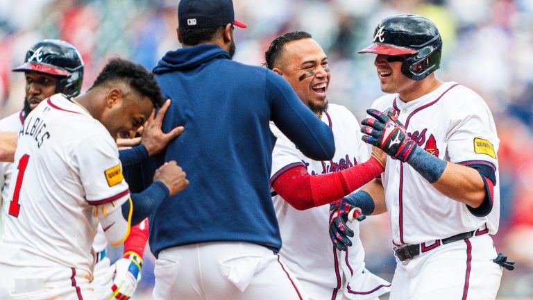 Marcell Ozuna #20, Ozzie Albies #1, Orlando Arcia #11, Reynaldo Lopez #40 and Austin Riley #27 of the Atlanta Braves celebrate after Riley hit a walk off single in the tenth inning against the Cleveland Guardians at Truist Park.