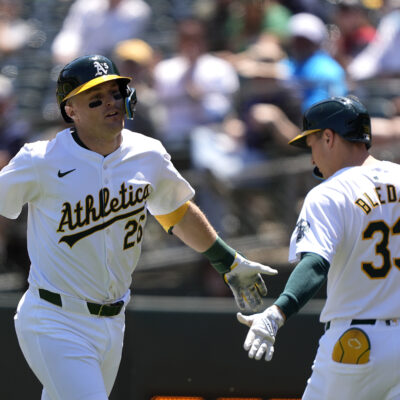 Tyler Nevin #26 of the Oakland Athletics is congratulated by JJ Bleday #33 after Nevin hit a solo home run against the Pittsburgh Pirates in the bottom of the third inning on May 1, 2024 at the Oakland Coliseum.
