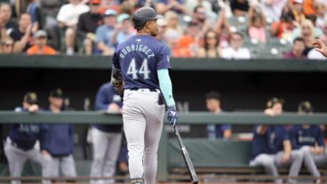 Julio Rodríguez of the Seattle Mariners walks back to the dug out after striking out in the first inning during a baseball game against the Baltimore Orioles at Oriole Park at Camden Yards.