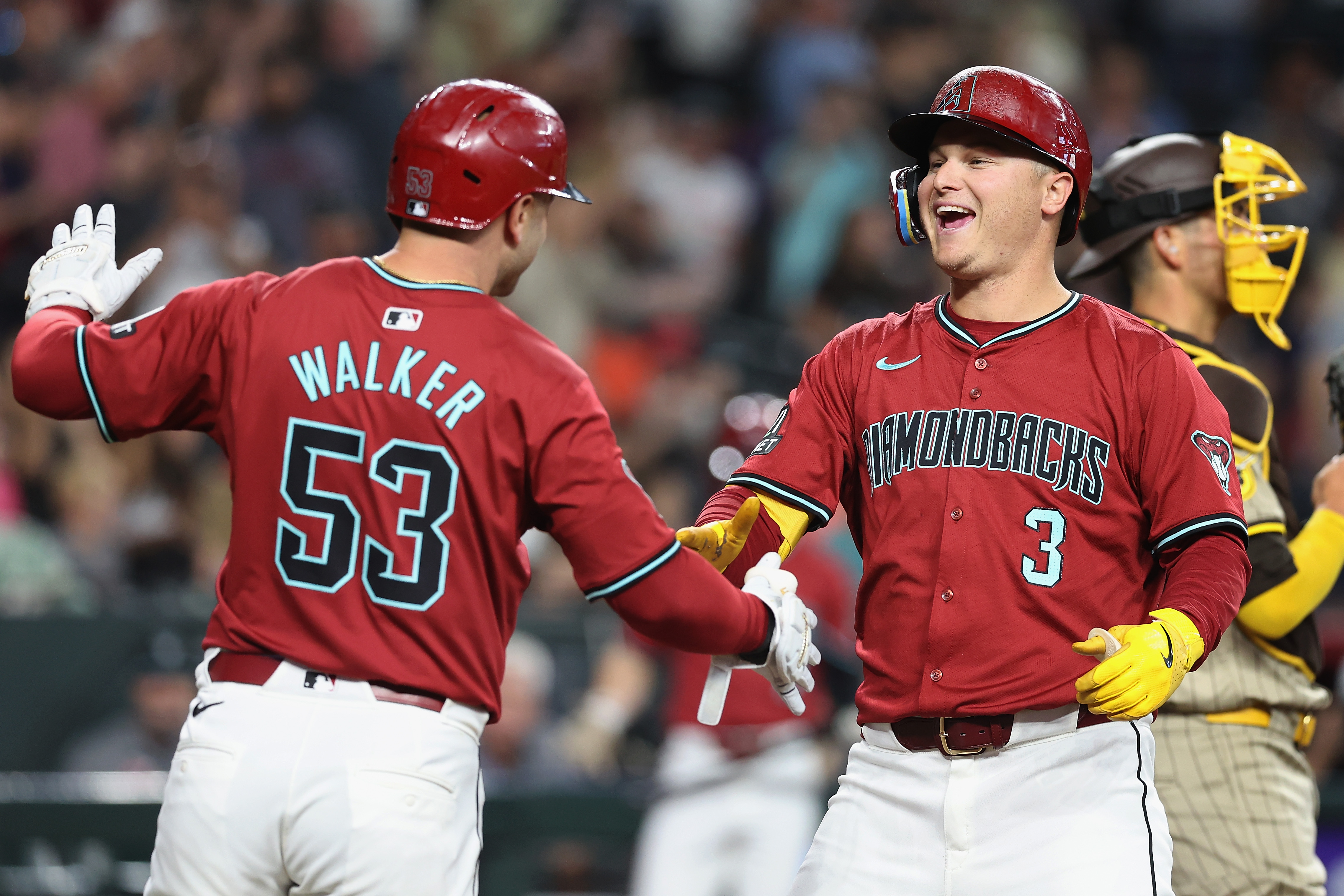 Joc Pederson of the Arizona Diamondbacks celebrates with Christian Walker after hitting a two-run home run against the San Diego Padres during the fourth inning of the MLB game at Chase Field.