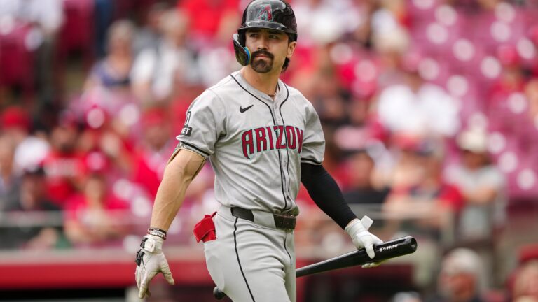 Corbin Carroll of the Arizona Diamondbacks walks back to the dugout after striking out in the first inning against the Cincinnati Reds at Great American Ball Park.