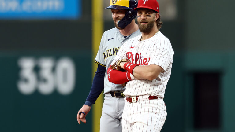 Rhys Hoskins of the Milwaukee Brewers and Bryce Harper of the Philadelphia Phillies speak during the fifth inning at Citizens Bank Park.