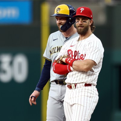 Rhys Hoskins of the Milwaukee Brewers and Bryce Harper of the Philadelphia Phillies speak during the fifth inning at Citizens Bank Park.