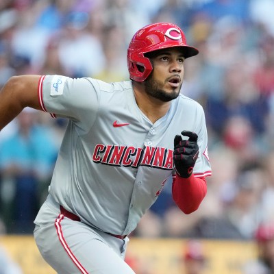 Jeimer Candelario of the Cincinnati Reds hits a double in the first inning against the Milwaukee Brewers at American Family Field.