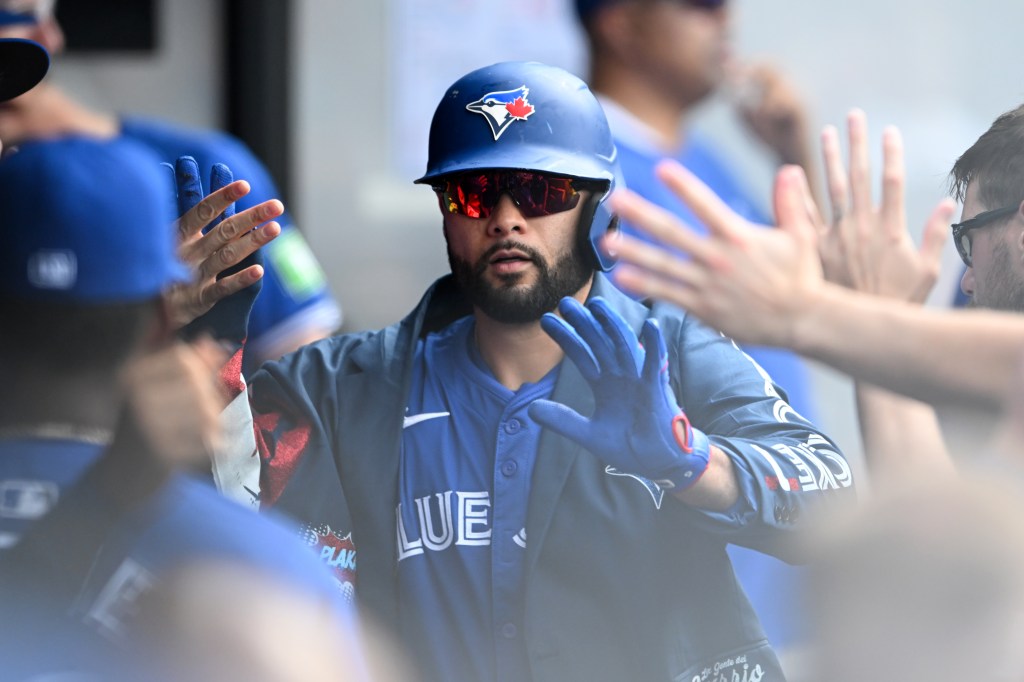Isiah Kiner-Falefa of the Toronto Blue Jays celebrates with teammates after hitting a solo home run during the third inning against the Cleveland Guardians at Progressive Field.