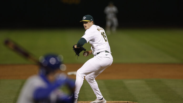 Mason Miller of the Oakland Athletics pitches during the game against the Kansas City Royals at the Oakland Coliseum.