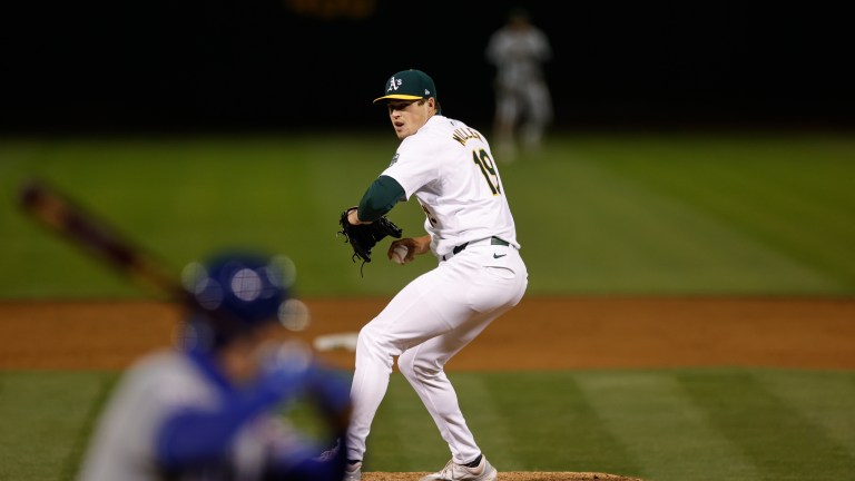 Mason Miller of the Oakland Athletics pitches during the game against the Kansas City Royals at the Oakland Coliseum.