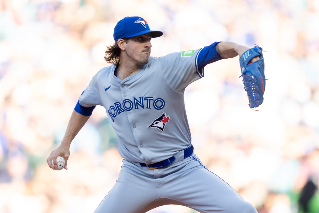 Starter Kevin Gausman #34 of the Toronto Blue Jays delivers a pitch during the first inning of a game against the Seattle Mariners at T-Mobile Park.