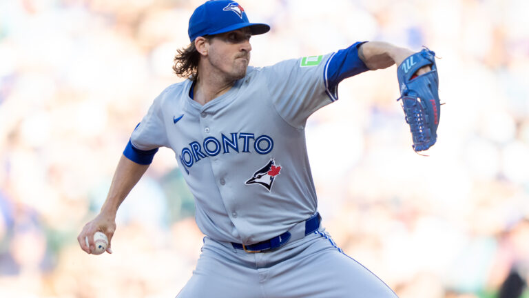 Starter Kevin Gausman #34 of the Toronto Blue Jays delivers a pitch during the first inning of a game against the Seattle Mariners at T-Mobile Park.