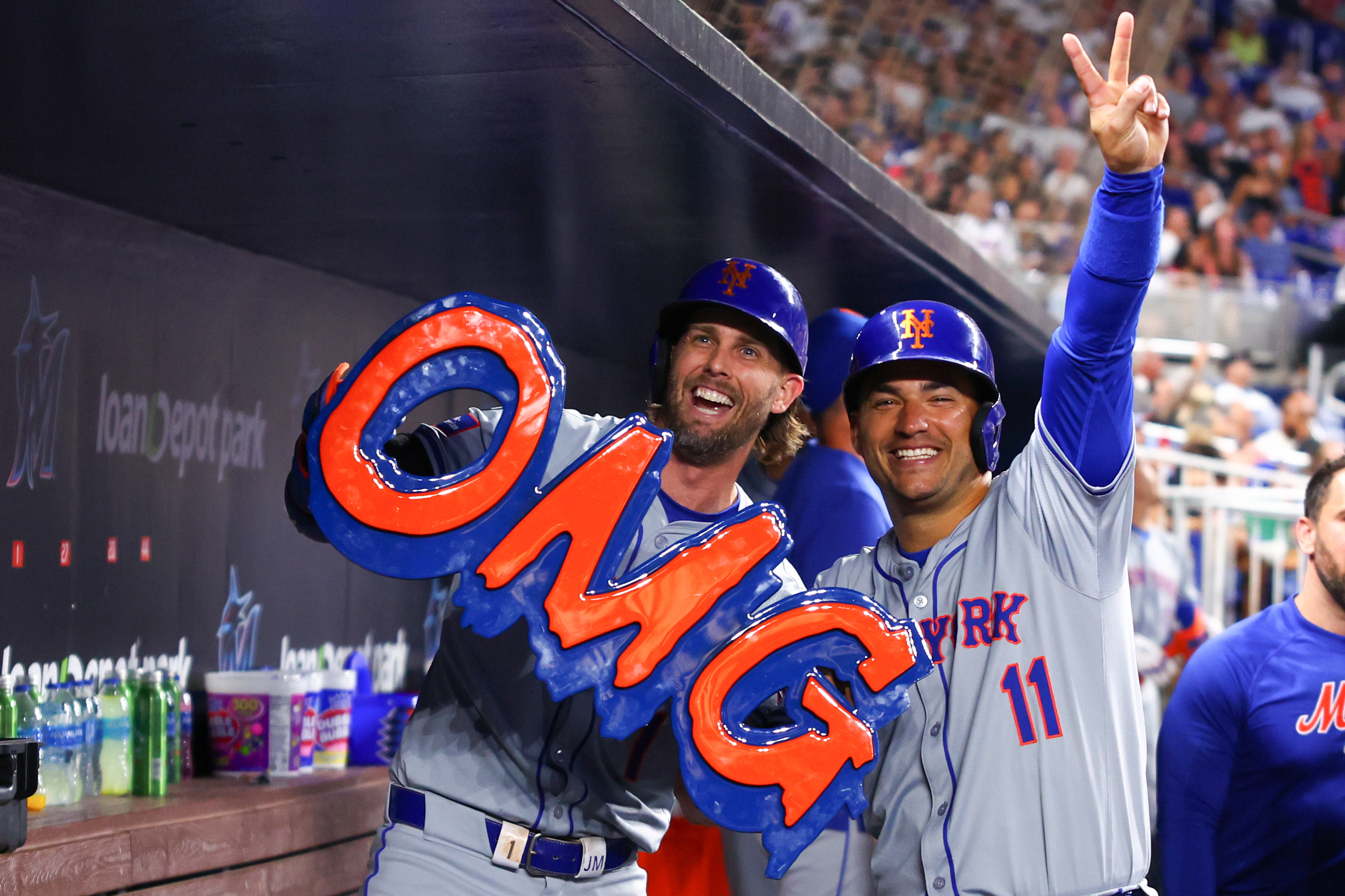Jeff McNeil of the New York Mets celebrates with teammate Jose Iglesias after hitting a home run against the Miami Marlins during the sixth inning of the game at loanDepot Park.