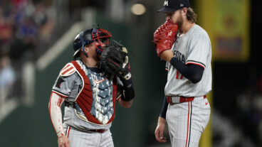 Christian Vázquez and Bailey Ober of the Minnesota Twins talk on the mound during the fourth inning against the Texas Rangers at Globe Life Field.