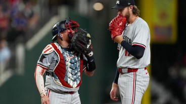 Christian Vázquez and Bailey Ober of the Minnesota Twins talk on the mound during the fourth inning against the Texas Rangers at Globe Life Field.