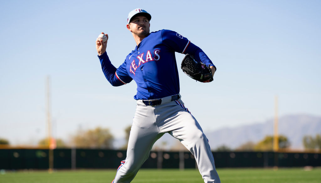 Tyler Mahle of the Texas Rangers warms up during a spring training workout at Surprise Stadium.