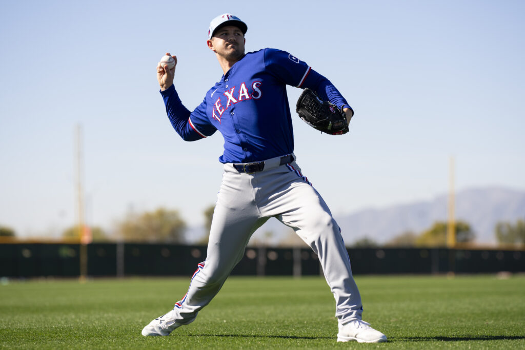 Tyler Mahle of the Texas Rangers warms up during a spring training workout at Surprise Stadium.