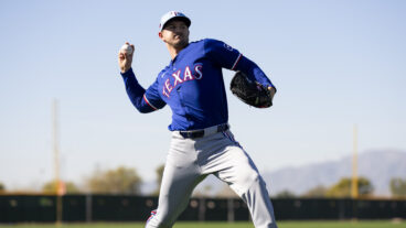 Tyler Mahle of the Texas Rangers warms up during a spring training workout at Surprise Stadium.