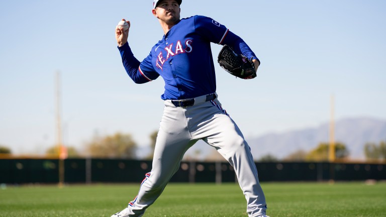 Tyler Mahle of the Texas Rangers warms up during a spring training workout at Surprise Stadium.