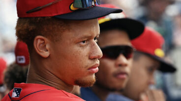 Outfield and second base prospect Kristian Campbell watches the action from the bench.