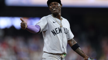 Jazz Chisholm Jr. of the New York Yankees smiles to a fan during the ninth inning against the Philadelphia Phillies at Citizens Bank Park in Philadelphia, Pennsylvania.