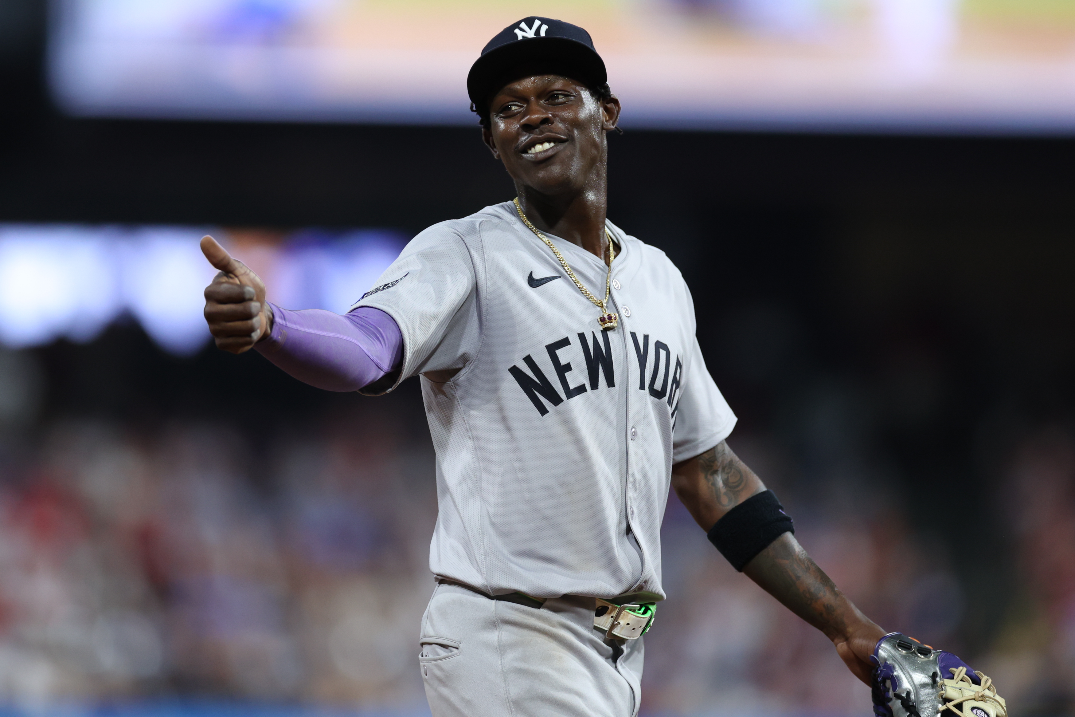 Jazz Chisholm Jr. of the New York Yankees smiles to a fan during the ninth inning against the Philadelphia Phillies at Citizens Bank Park in Philadelphia, Pennsylvania.