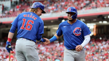 Patrick Wisdom #16 and Isaac Paredes #17 of the Chicago Cubs celebrate after Paredes scored in the against the Cincinnati Reds at Great American Ball Park.