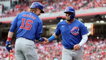 Patrick Wisdom #16 and Isaac Paredes #17 of the Chicago Cubs celebrate after Paredes scored in the against the Cincinnati Reds at Great American Ball Park.