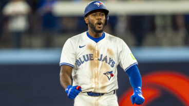 Blue Jays infielder Luis De Los Santos celebrates a base hit on second.
