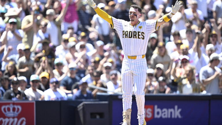 Jackson Merrill of the San Diego Padres celebrates after hitting a two-RBI triple against the Pittsburgh Pirates.