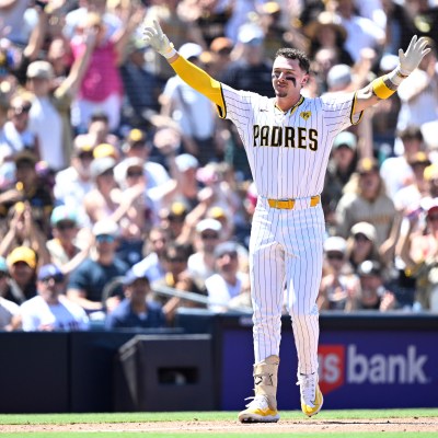 Jackson Merrill of the San Diego Padres celebrates after hitting a two-RBI triple against the Pittsburgh Pirates.