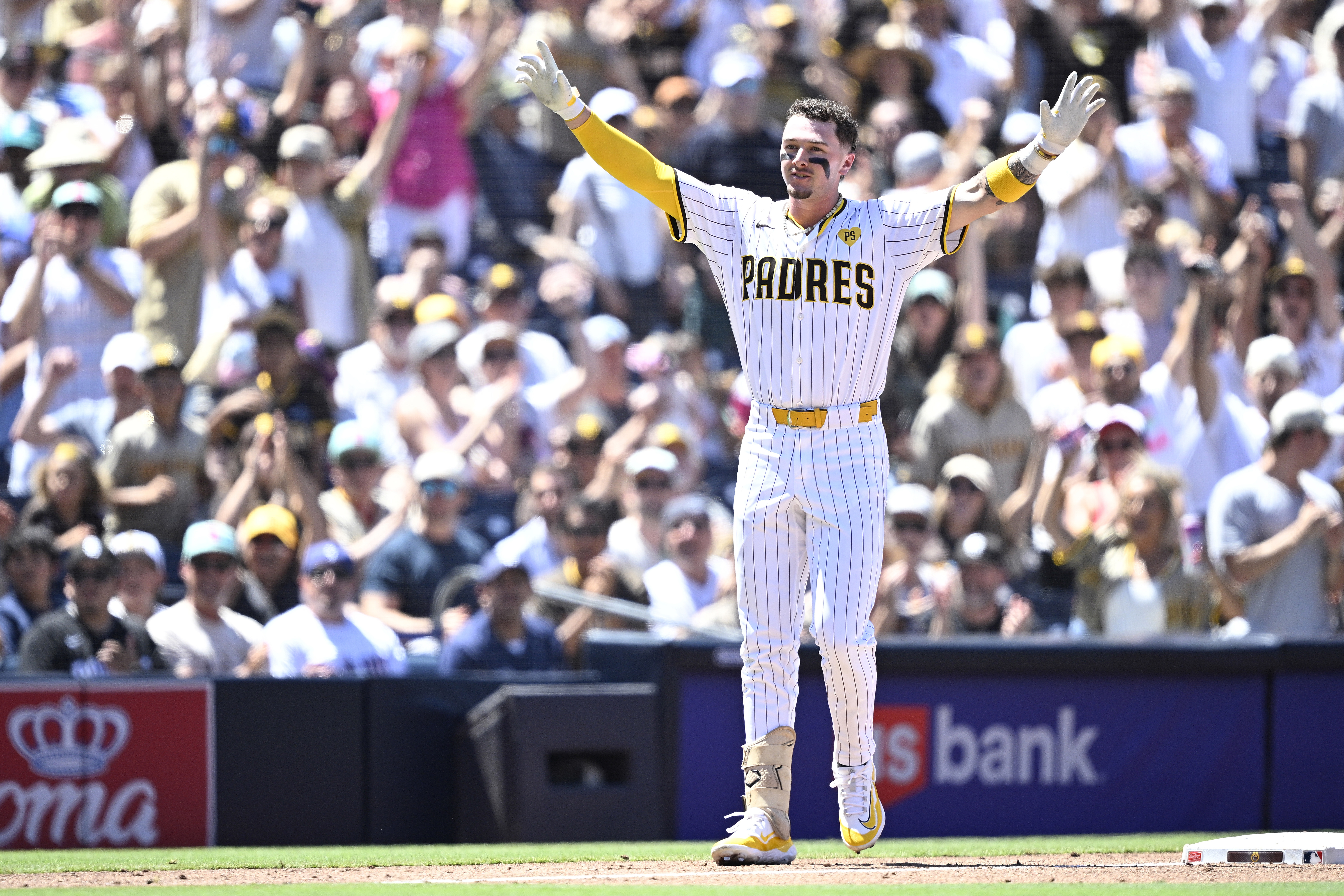 Jackson Merrill of the San Diego Padres celebrates after hitting a two-RBI triple against the Pittsburgh Pirates.