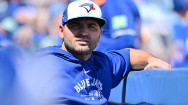 Joey Votto of the Toronto Blue Jays looks on from the dugout during a 2024 Grapefruit League Spring Training game against the Baltimore Orioles at TD Ballpark.
