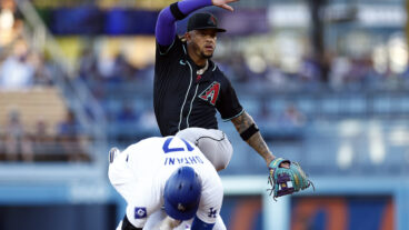 Ketel Marte of the Arizona Diamondbacks mimics the hit Los Angeles Dodgers double celebration in front of Shohei Ohtani in the first inning at Dodger Stadium.