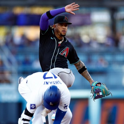 Ketel Marte of the Arizona Diamondbacks mimics the hit Los Angeles Dodgers double celebration in front of Shohei Ohtani in the first inning at Dodger Stadium.
