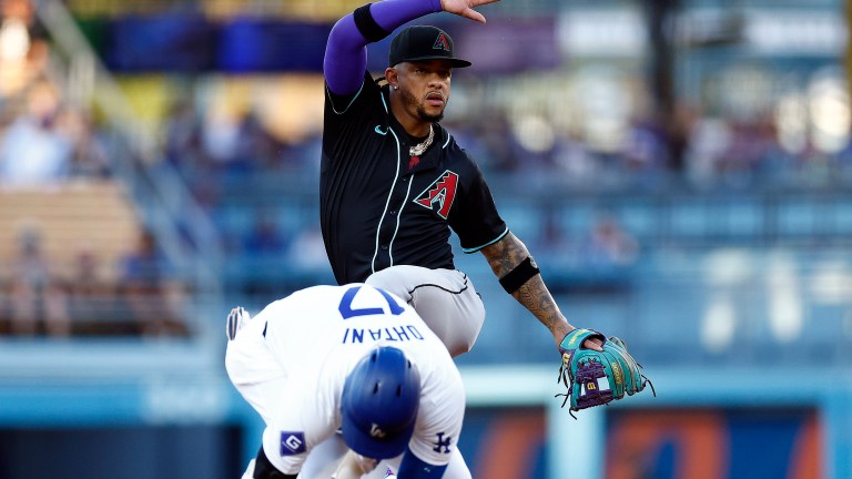 Ketel Marte of the Arizona Diamondbacks mimics the hit Los Angeles Dodgers double celebration in front of Shohei Ohtani in the first inning at Dodger Stadium.