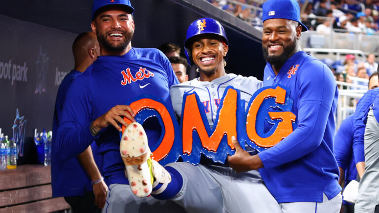 Francisco Lindor #12 of the New York Mets celebrates with teammates Sean Manaea #59 (L) and Luis Severino #40 (R) after hitting a home run against the Miami Marlins during the ninth inning of the game at loanDepot park.