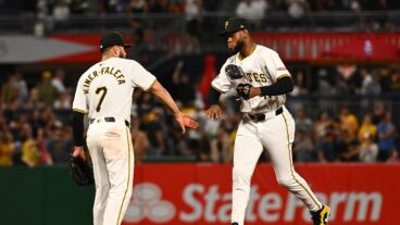 Isiah Kiner-Falefa #7 of the Pittsburgh Pirates celebrates with Bryan De La Cruz #41 after the final out in a 4-2 win over the Arizona Diamondbacks.