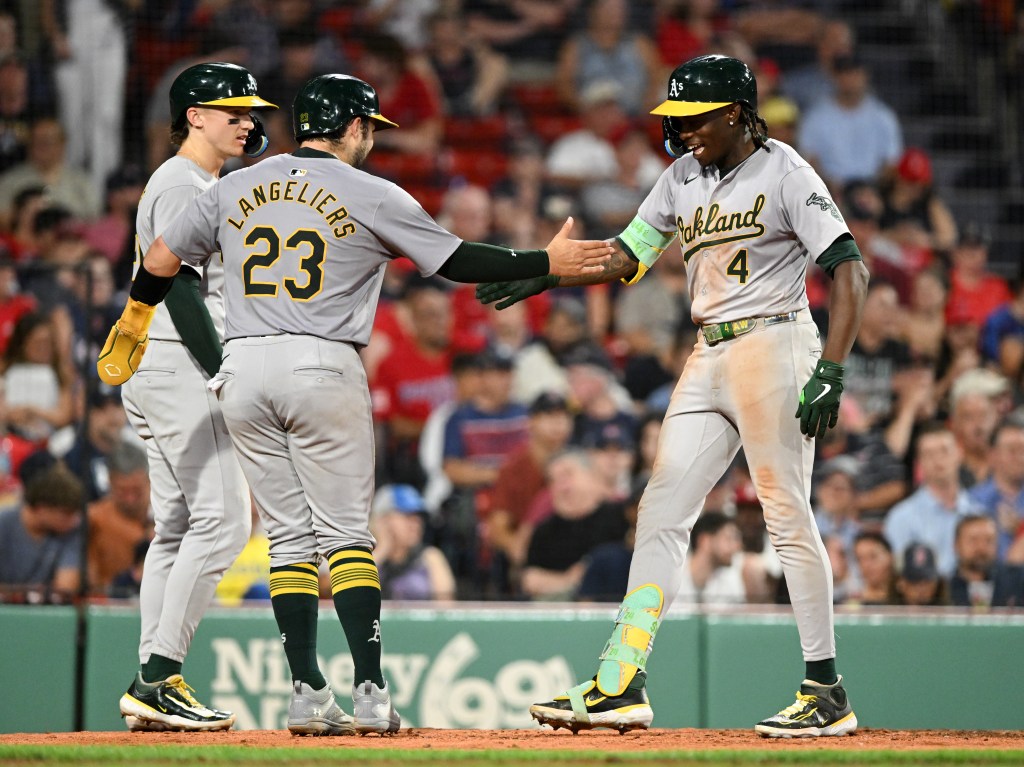 Breakout star Lawrence Butler of the Oakland Athletics celebrates with Shea Langeliers #23 and Zack Gelof #20 after hitting a three-run home run.
