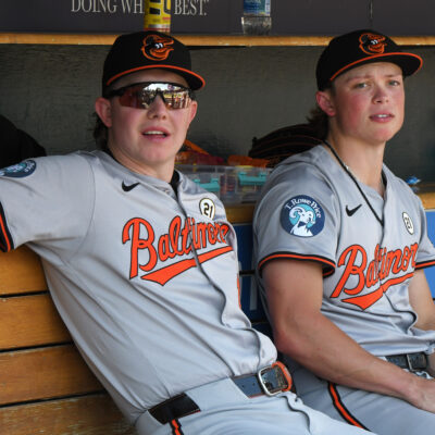 Heston Kjerstad and Jackson Holliday of the Baltimore Orioles look on from the dugout during the game against the Detroit Tigers at Comerica Park.