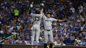 KANSAS CITY, MO - OCTOBER 9: Giancarlo Stanton #27 of the New York Yankees high fives Jazz Chisholm Jr. #13 after hitting a home run in the eighth inning of Game Three of the Division Series against the Kansas City Royals at Kauffman Stadium on October 9, 2024 in Kansas City, Missouri. (Photo by New York Yankees/Getty Images)