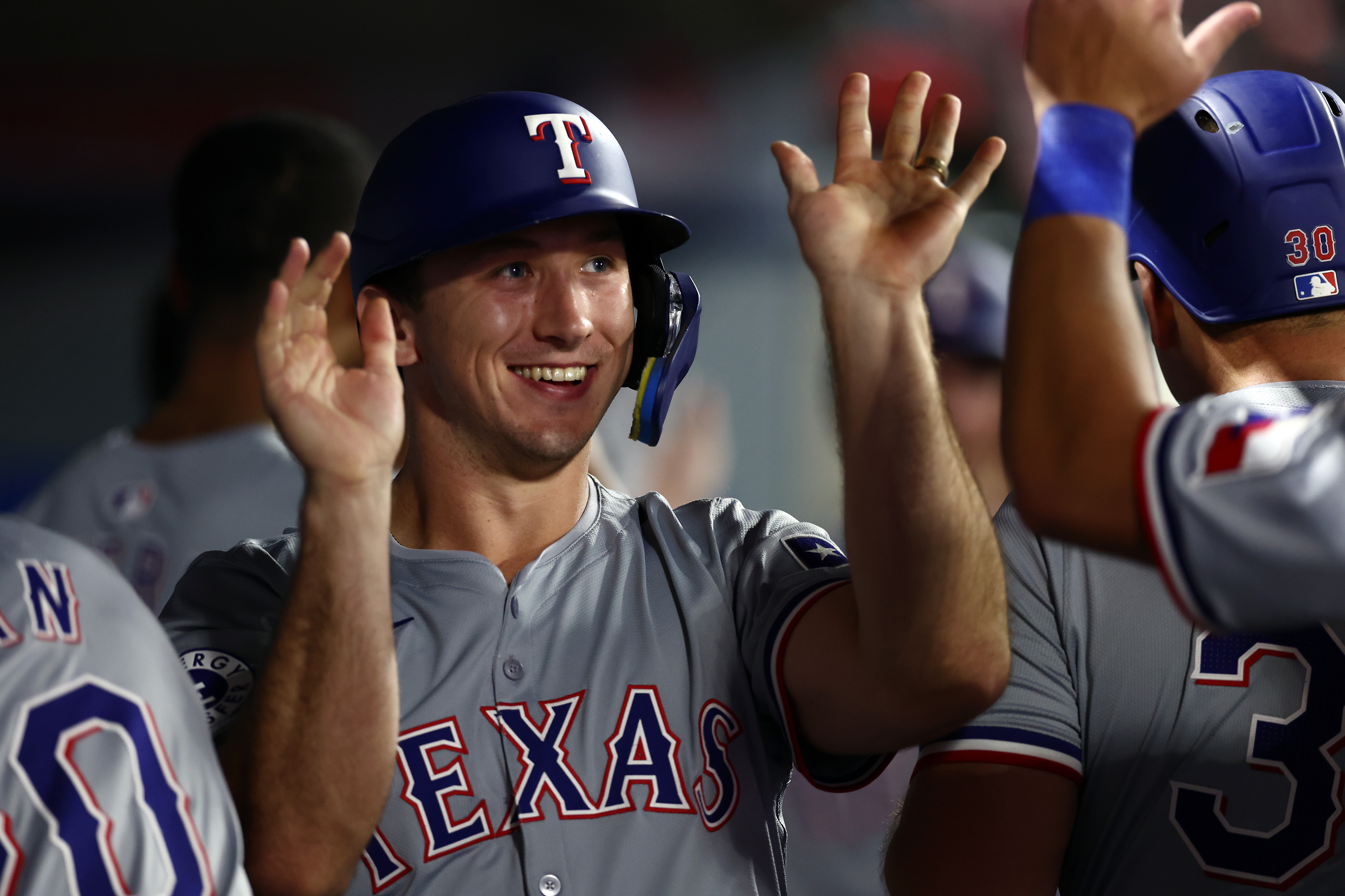 ANAHEIM, CALIFORNIA - SEPTEMBER 28: Wyatt Langford #36 of the Texas Rangers celebrates runs scored with teammates in the dugout in during the ninth inning against the Los Angeles Angels at Angel Stadium of Anaheim on September 28, 2024 in Anaheim, California. (Photo by Katelyn Mulcahy/Getty Images)